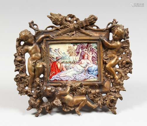 A CLASSICAL PORCELAIN PLAQUE, 2.25ins x 3.75ins, in a cased bronze frame with cupids and trophies.