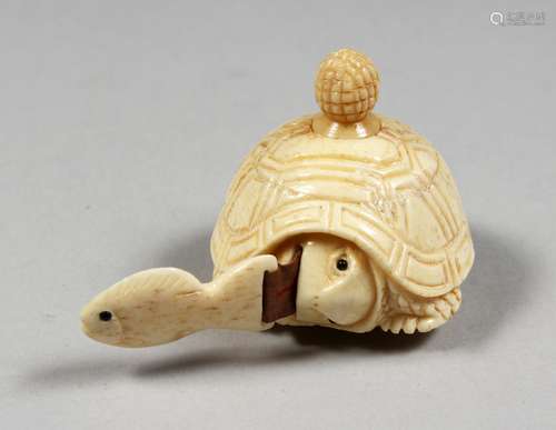 A CARVED BONE TORTOISE TAPE MEASURE.