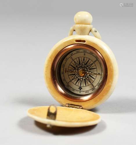 A CARVED BONE WATCH SHAPED COMPASS, engraved with a sailing ship.