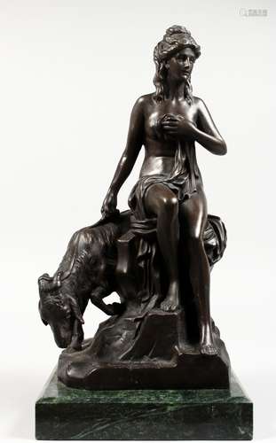 A BRONZE GROUP OF A CLASSICAL YOUNG LADY, sitting on a rock, a goat by her side. Signed, on a