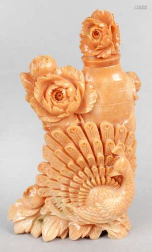 A carved coral snuff bottle and stopper with carved peacock and floral decoration,