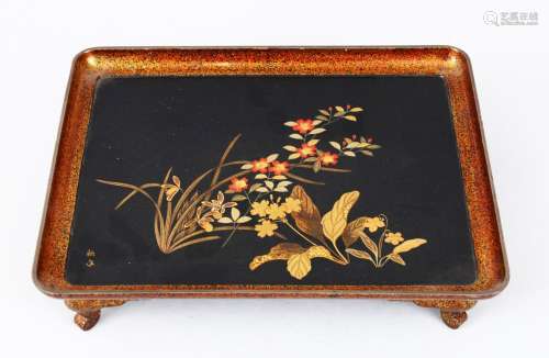 A GOOD JAPANESE MEIJI PERIOD LACQUER TRAY ON FEET, the tray decorated with scenes of native flora,