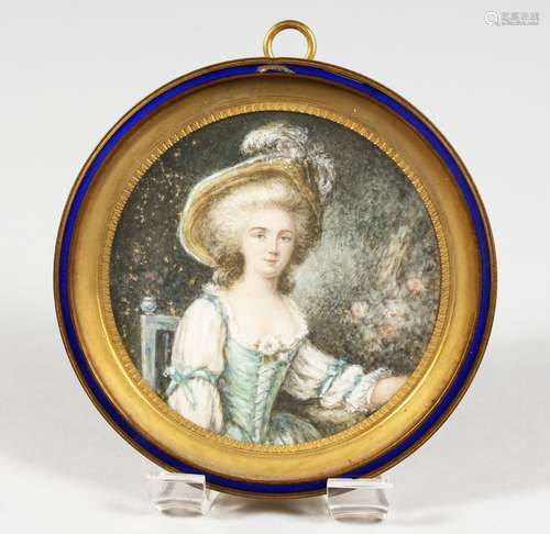 A GOOD FRENCH CIRCULAR MINIATURE PORTRAIT OF A YOUNG LADY, in a gilt and blue enamel frame. 3.5ins