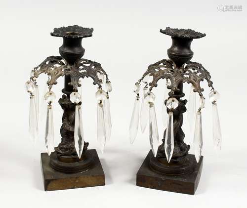 A PAIR OF BRONZE LUSTRE CANDLESTICKS, with cut glass prism drops, on square bases. 9ins high.