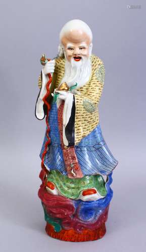 A GOOD 19TH / 20TH CENTURY CHINESE FAMILLE ROSE PORCELAIN FIGURE OF SHOU LAO, stood holding his