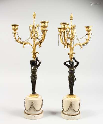 A VERY GOOD PAIR OF EMPIRE BRONZE ORMOLU CANDELABRA, as bronze classical figures, holding three