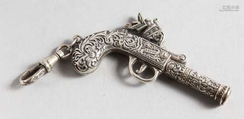 A NOVELTY SILVER PISTOL WHISTLE. 2.25ins long.