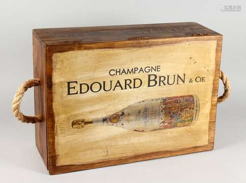 A NOVELTY WOODEN BOX, decorated with a champagne bottle. 21,5ins wide.