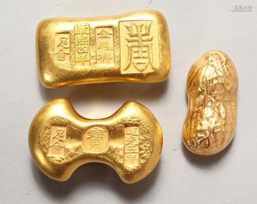 THREE NOVELTY CHINESE GOLDEN-COLOURED SCROLL WEIGHTS. 2ins and 2.5ins long.