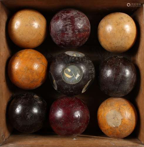 A SET OF NINE WOODEN CARPET BOWLS, 3.5ins diameter, one numbered 1-8.