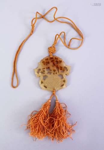 A GOOD CHINESE CARVED JADE PENDANT, depicting a floral spray of flora with silk tie, 5.5cm.