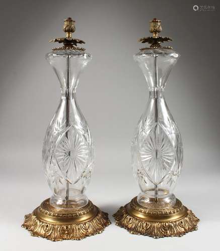 A GOOD PAIR OF CUT GLASS STANDARD LAMPS, with gilt metal bases.