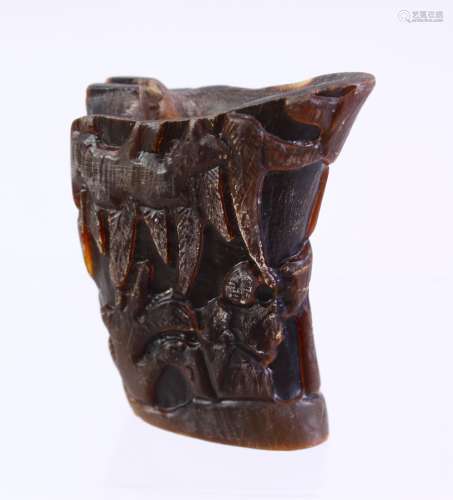 A CHINESE CARVED HORN LIBATION CUP, carved with figures in landscapes, 6cm.