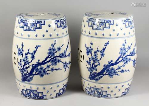 A PAIR OF CHINESE BLUE AND WHITE POTTERY BARREL SEATS. 12ins high.