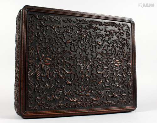 A WELL CARVED CHINESE HARDWOOD BOX AND COVER. 14ins wide.