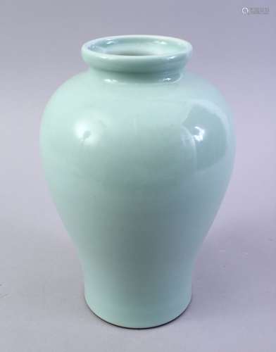 A CHINESE CELADON GLAZED PORCELAIN VASE, the base with a six character mark, 25cm high.