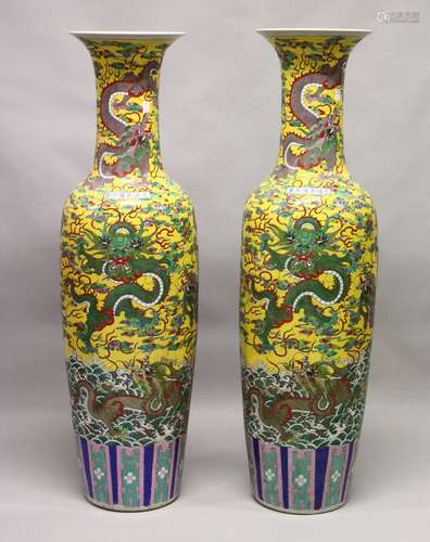 A LARGE PAIR OF CHINESE FAMILLE JAUNE FLOOR STANDING VASES. 56ins high.