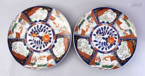 TWO GOOD JAPANESE MEIJI PERIOD IMARI CHARGERS, decorated with panels of landscapes and birds,