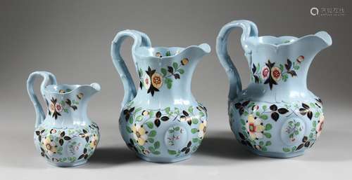 A GRADUATED SET OF THREE LATE 19TH CENTURY RIDGWAY JUGS, pale blue ground with floral decoration.