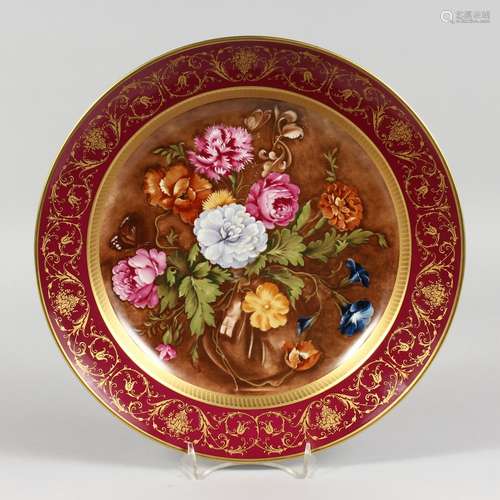 A GERMAN PORCELAIN CIRCULAR PLATTER, painted with flowers after Cornelis de Heem. 12ins diameter.