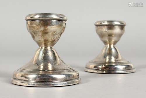 A PAIR OF DWARF SILVER CANDLESTICKS. Birmingham 1974. 2.25ins high.