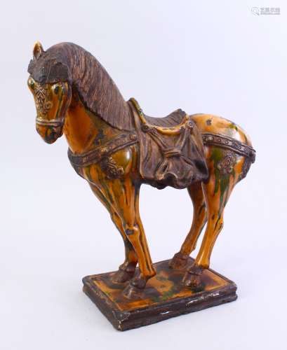 A CHINESE SANCAI DECORATED TANG STYLE POTTERY HORSE MODEL, stood in an elegant pose, decorated
