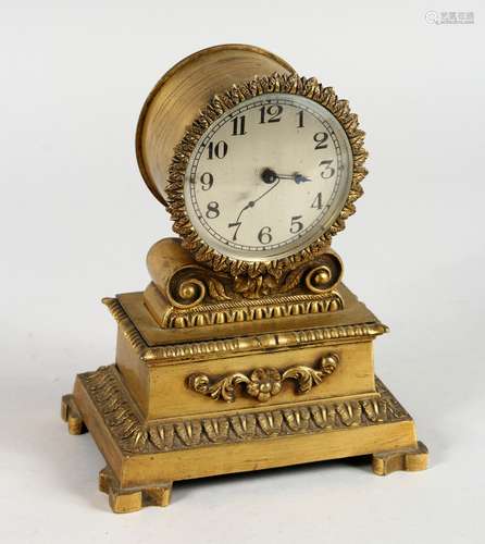 A SMALL EMPIRE GILT METAL CLOCK. 7ins high.