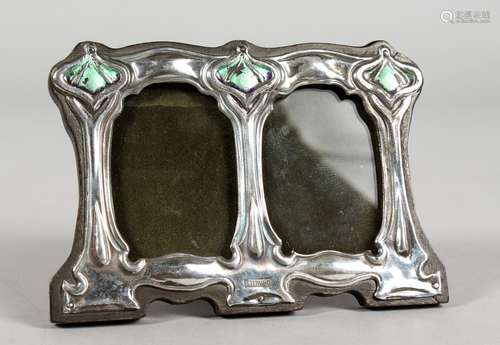 AN ART NOUVEAU STYLE SILVER AND ENAMEL DOUBLE PHOTOGRAPH FRAME. 4.5ins wide x 3ins high.