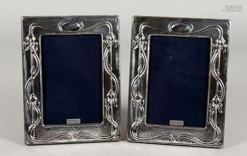 A PAIR OF ART NOUVEAU STYLE SILVER PHOTO FRAMES. 7.5ins x 5.75ins.