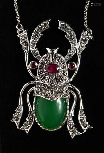 A SILVER JADE SET SCARAB PENDANT on chain.