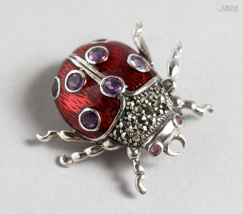 A SILVER, RED ENAMEL AND AMETHYST LADYBIRD BROOCH.