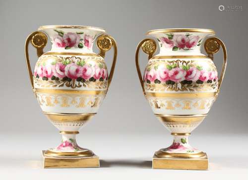 A PAIR OF SPODE TWO-HANDLED URN SHAPED VASES, with gilt decoration painted with roses. 7ins high.