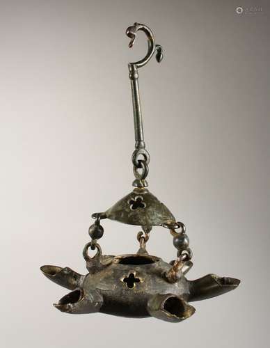 A BYZANTINE BRONZE LAMP with six nozzles and suspension chain. 7.5ins wide.