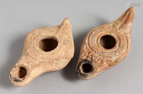 TWO SMALL TERRACOTTA OIL LAMPS.