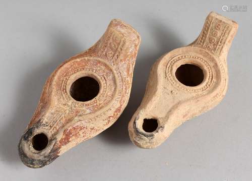 TWO SMALL TERRACOTTA OIL LAMPS.