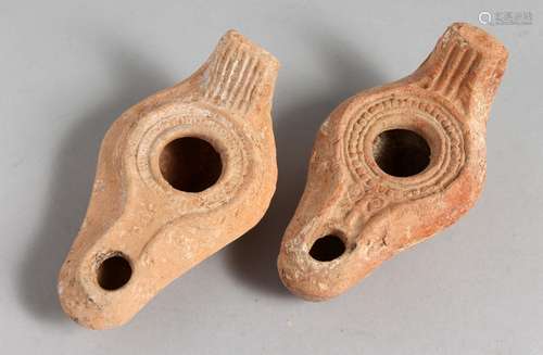 TWO SMALL TERRACOTTA OIL LAMPS.