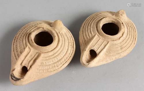 TWO SMALL TERRACOTTA OIL LAMPS.