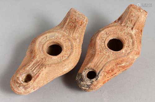 TWO SMALL TERRACOTTA OIL LAMPS.