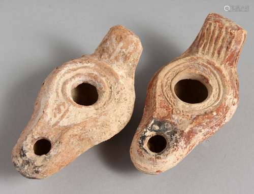 TWO SMALL TERRACOTTA OIL LAMPS.