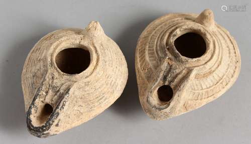 TWO SMALL TERRACOTTA OIL LAMPS.