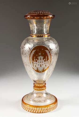 A LATE 19TH CENTURY BOHEMIAN AMBER TINTED GLASS LAMP BASE, engraved with a stately home and fruiting