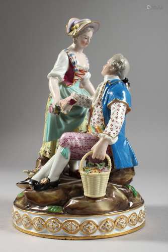 A GOOD MEISSEN PORCELAIN GROUP OF A GALLANT AND LADY, the gallant seated holding a basket of