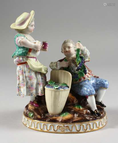 A GOOD MEISSEN PORCELAIN GROUP OF A YOUNG BOY AND GIRL, the boy seated beside and holding fruiting