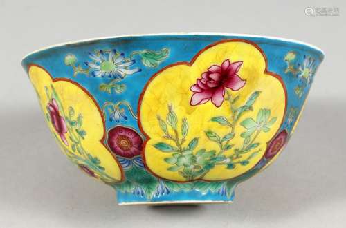 A CHINESE PORCELAIN BOWL, blue ground, painted with panels of flowers. 6ins diameter.