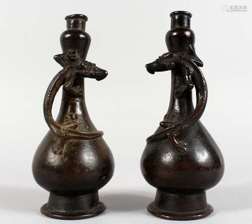 A GOOD SMALL PAIR OF CHINESE BRONZE GARLIC NECK BOTTLE VASE, each entwined with a lizard. 7ins