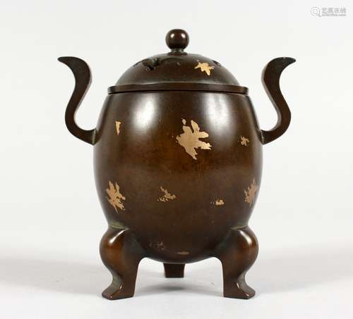 A SMALL CHINESE GOLD SPLASH TWIN-HANDLED BRONZE CENSER ON THREE FEET. 4.75ins high.