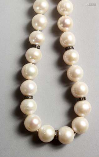 A PEARL NECKLACE, with 18ct white gold clasp and small diamond interspersed sections. 17ins long.