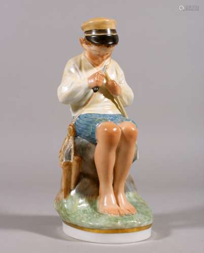 A COPENHAGEN PORCELAIN FIGURE OF A YOUNG BOY sitting on a rock and cutting a stick. Pattern 905. 7.