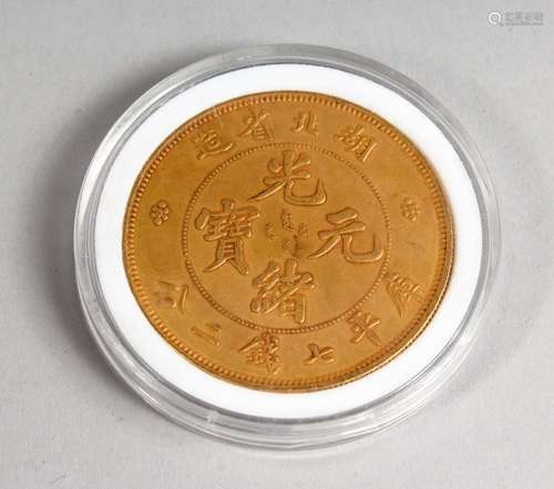 A CHINESE GILT METAL COIN, cased. 1.5ins diameter.