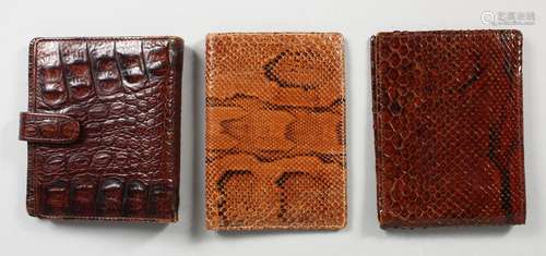 THREE CROCODILE AND SNAKESKIN WALLETS/NOTEBOOKS. 5ins wide.